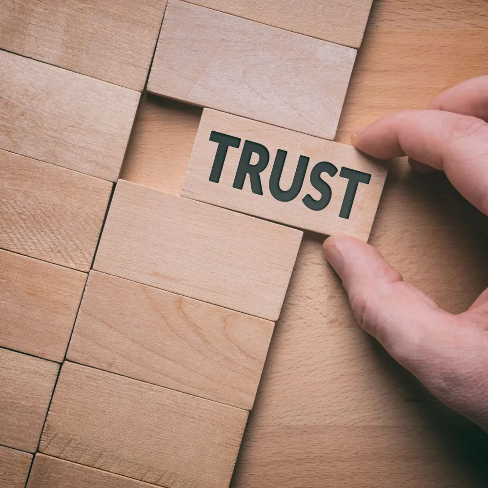 Sliding in a wooden block with word trust written on it